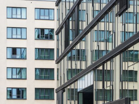 Close-up view of contemporary office and residential buildings with glass facades.