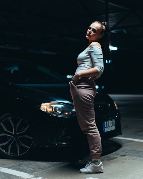 Woman Standing near Black Car