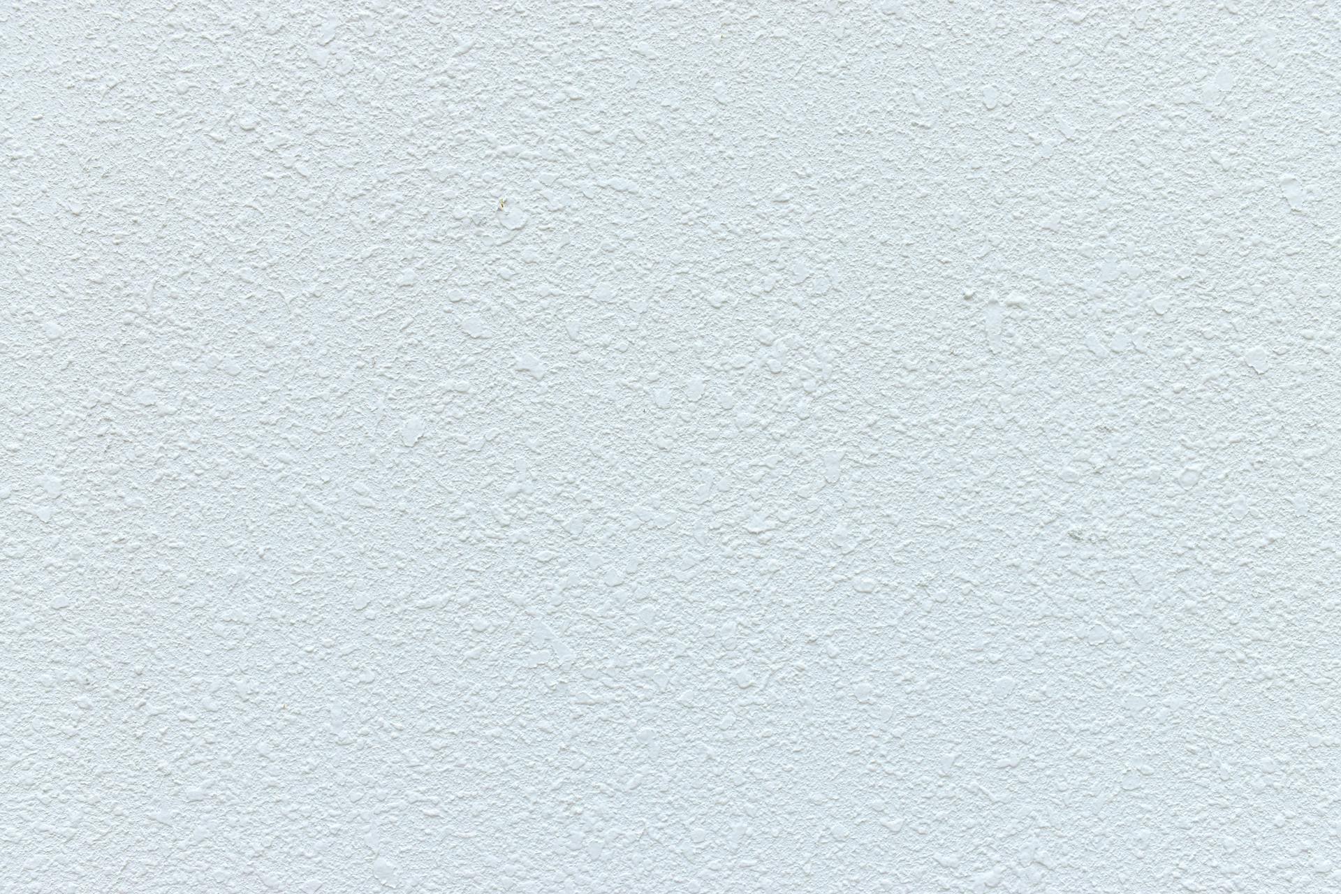 Detailed close-up of a textured white wall, perfect for backgrounds and designs.