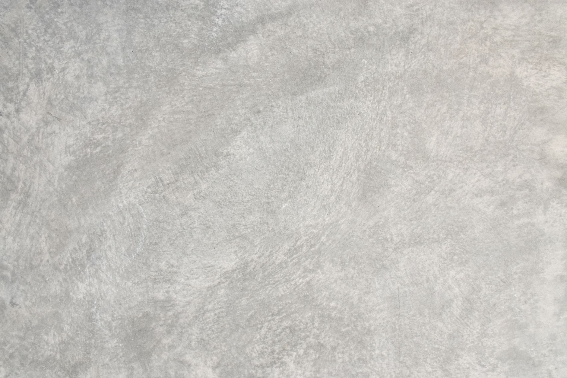 Close-up of a textured concrete surface displaying subtle abstract patterns.