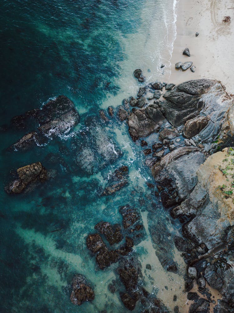 Water Around Rocks On Shore