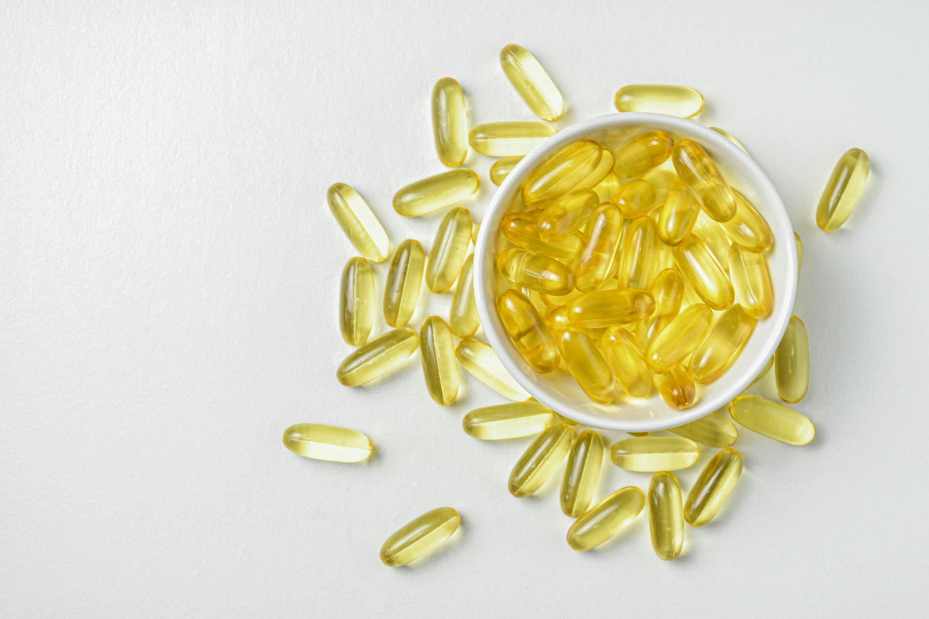 https://www.pexels.com/photo/flat-lay-of-fish-oil-gold-capsule-on-background-food-supplement-vitamin-d-vitamin-e-omega-3-16776311/