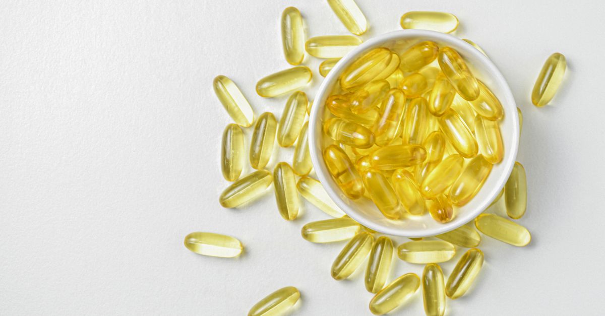 High-angle shot of omega-3 fish oil capsules in a ceramic bowl on a white background. - Evidence evidence guide for vitamin e skin health randomized trial