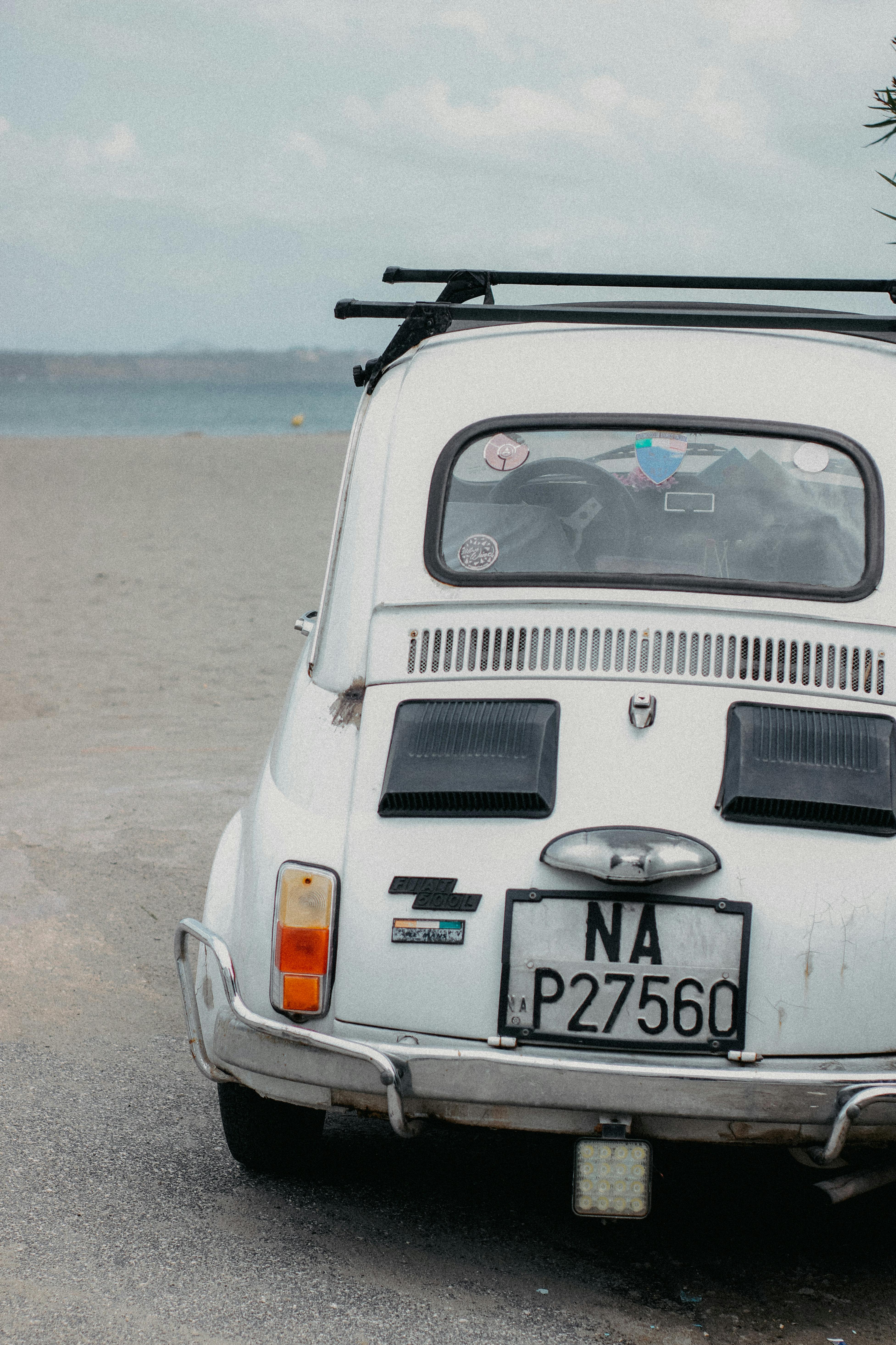 White Vintage Car Parked on Beach Sand · Free Stock Photo