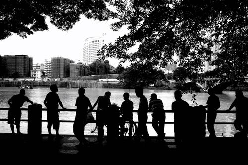 People Standing Behind Railing Silhouette of a Person Sitting Behind a Glass Railing · Free Stock Photo