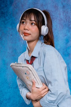 Contemporary portrait of a young woman with headphones and a tablet. Perfect for lifestyle and tech themes.