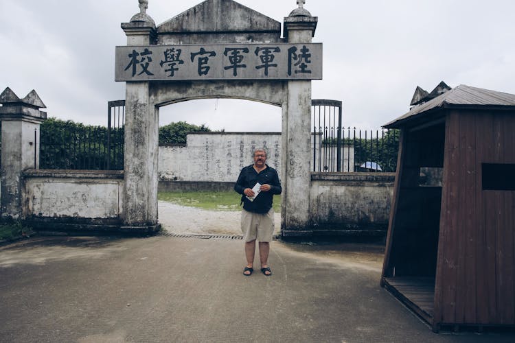 A Man In Front Of Military Academy In China