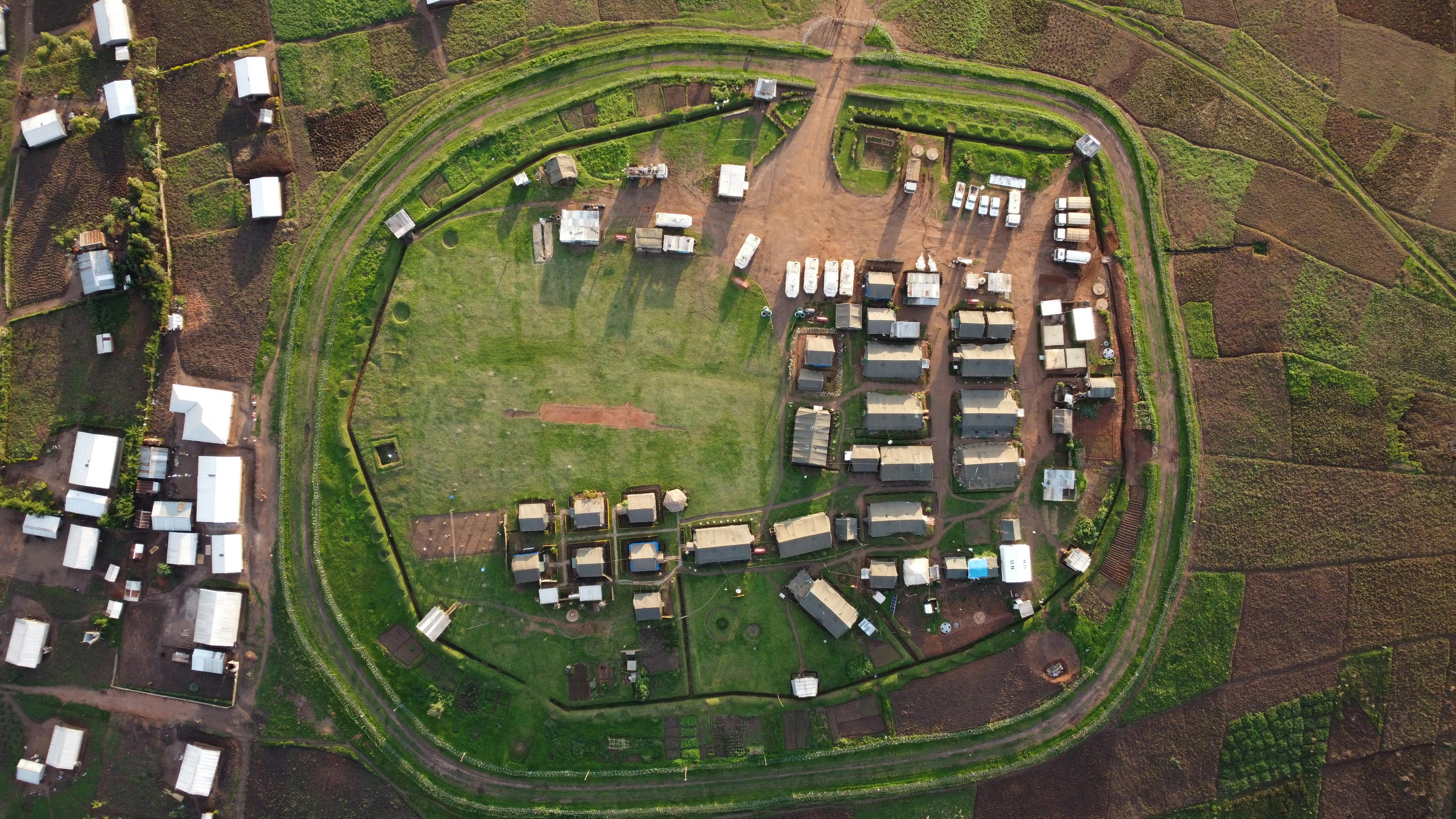 Aerial shot of Bule village showcasing circular layout and lush surroundings in Ituri, DR Congo.