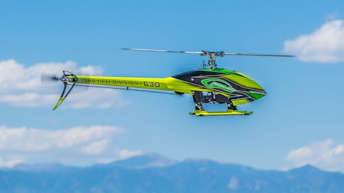 Free Green Black and Yellow Heli Division 630 Helicopter Stock Photo