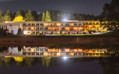 Free Beautiful night view of a lakeside holiday resort with lights reflecting on the water. Stock Photo