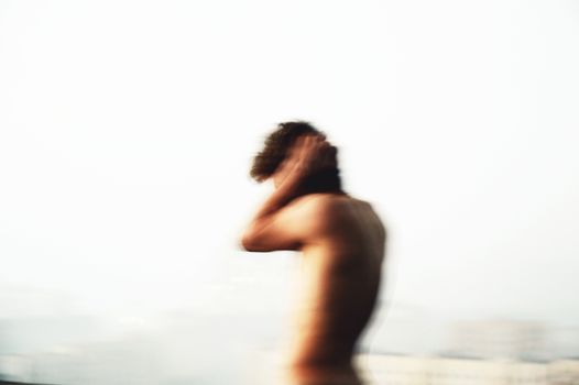 Blurry Photo of Shirtless Man on White Ba