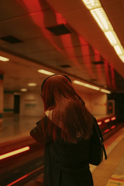 Redhead Woman Standing on Platform in Subway