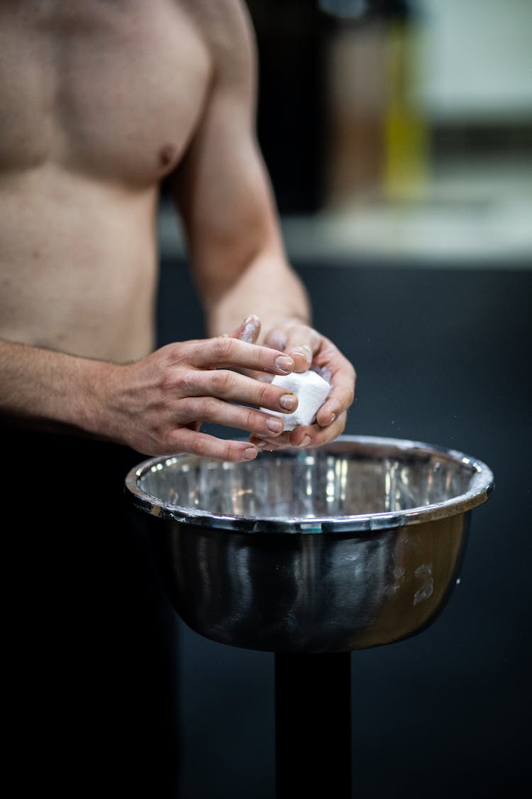 Man Coating Hands With Powder Chalk Magnesium In Gym