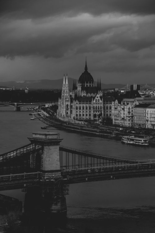 Free A dramatic black and white view of Budapest featuring bridges and the iconic skyline. Stock Photo