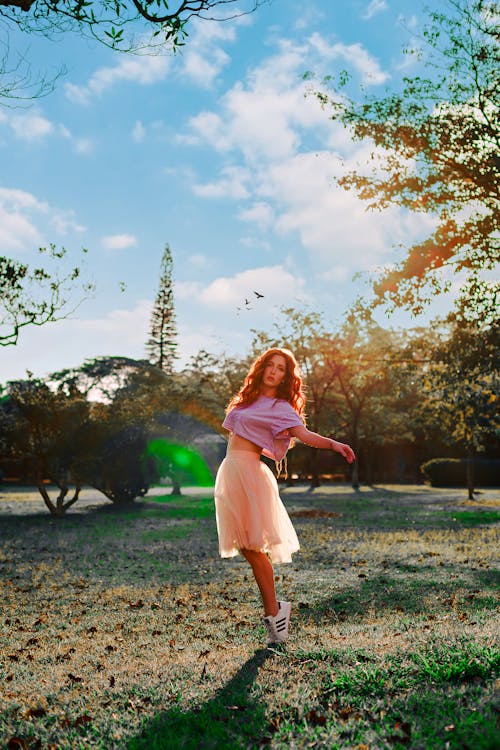 Woman in Skirt Dancing in Park