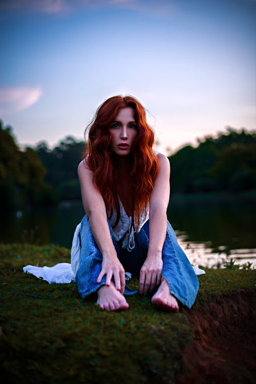 Redhead Woman Sitting on Grass