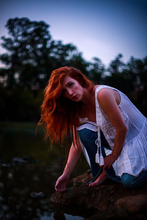 Redhead Woman near River on Sunset