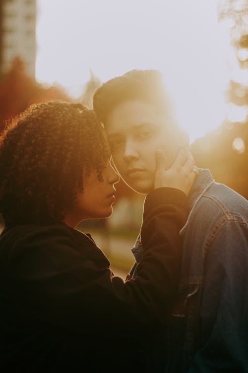 Young Couple Standing Close at Sunset 