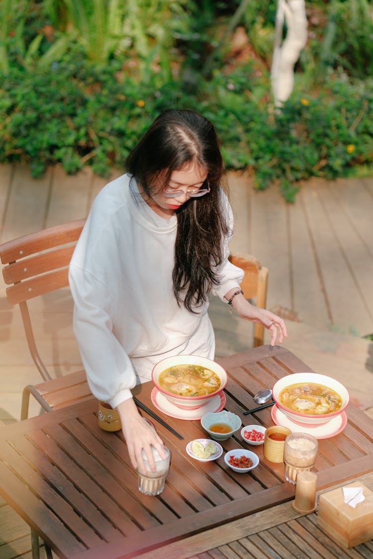 Woman Setting Outdoor Table For A Meal