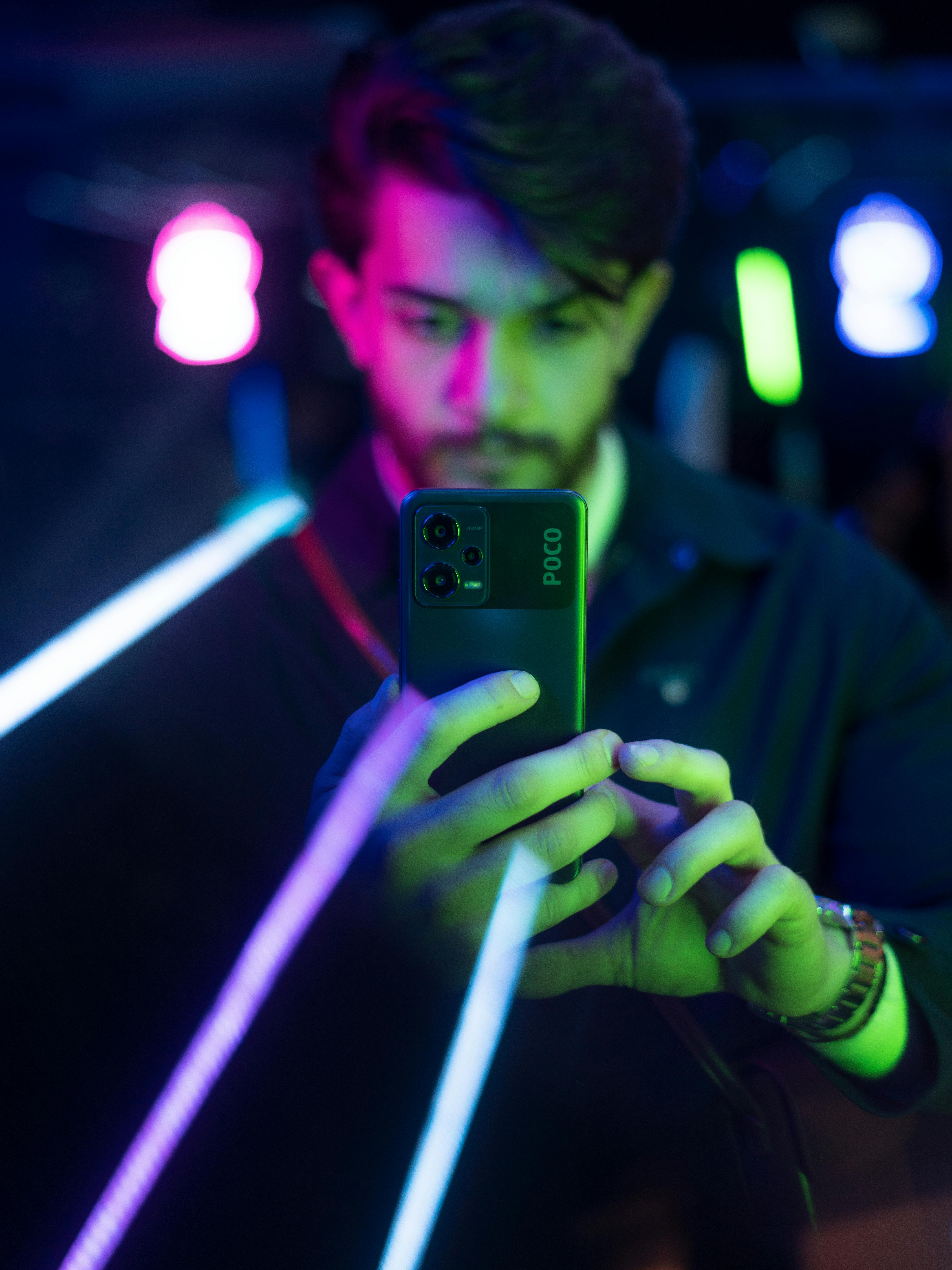 lights over man holding cellphone