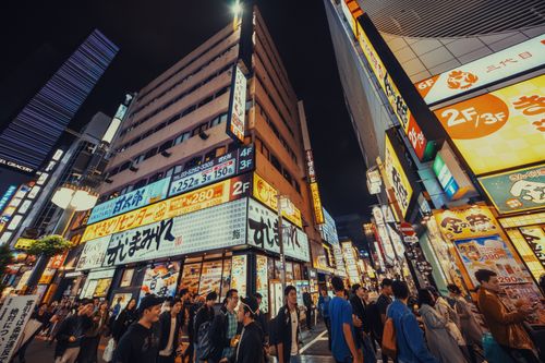 Free A bustling street in Tokyo filled with neon lights and diverse crowds, showcasing vibrant urban life at night. Stock Photo