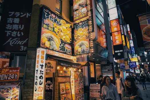 Bustling Tokyo street adorned with bright neon signs and lively atmosphere, capturing urban nightlife.