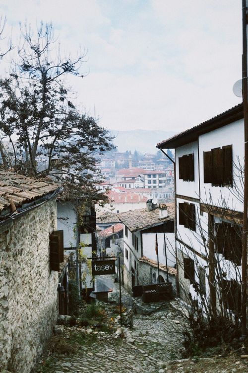 Free Picturesque view of a cobblestone alley with historic buildings in winter. Stock Photo