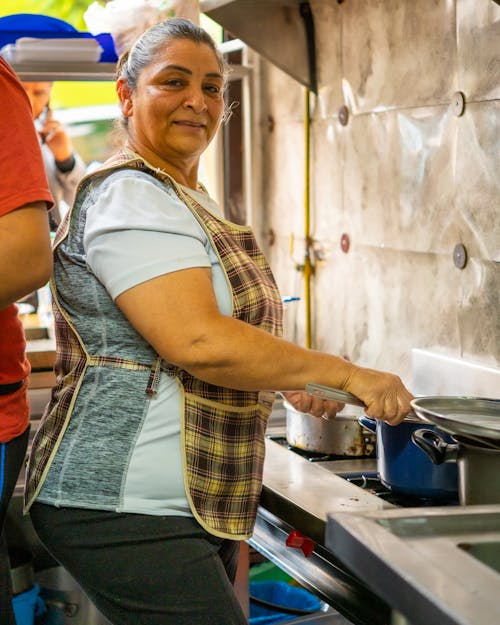 Woman Preparing Food in a Restaurant Kitchen 