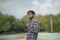 A Man Wearing Checkered Shirt on a Beach