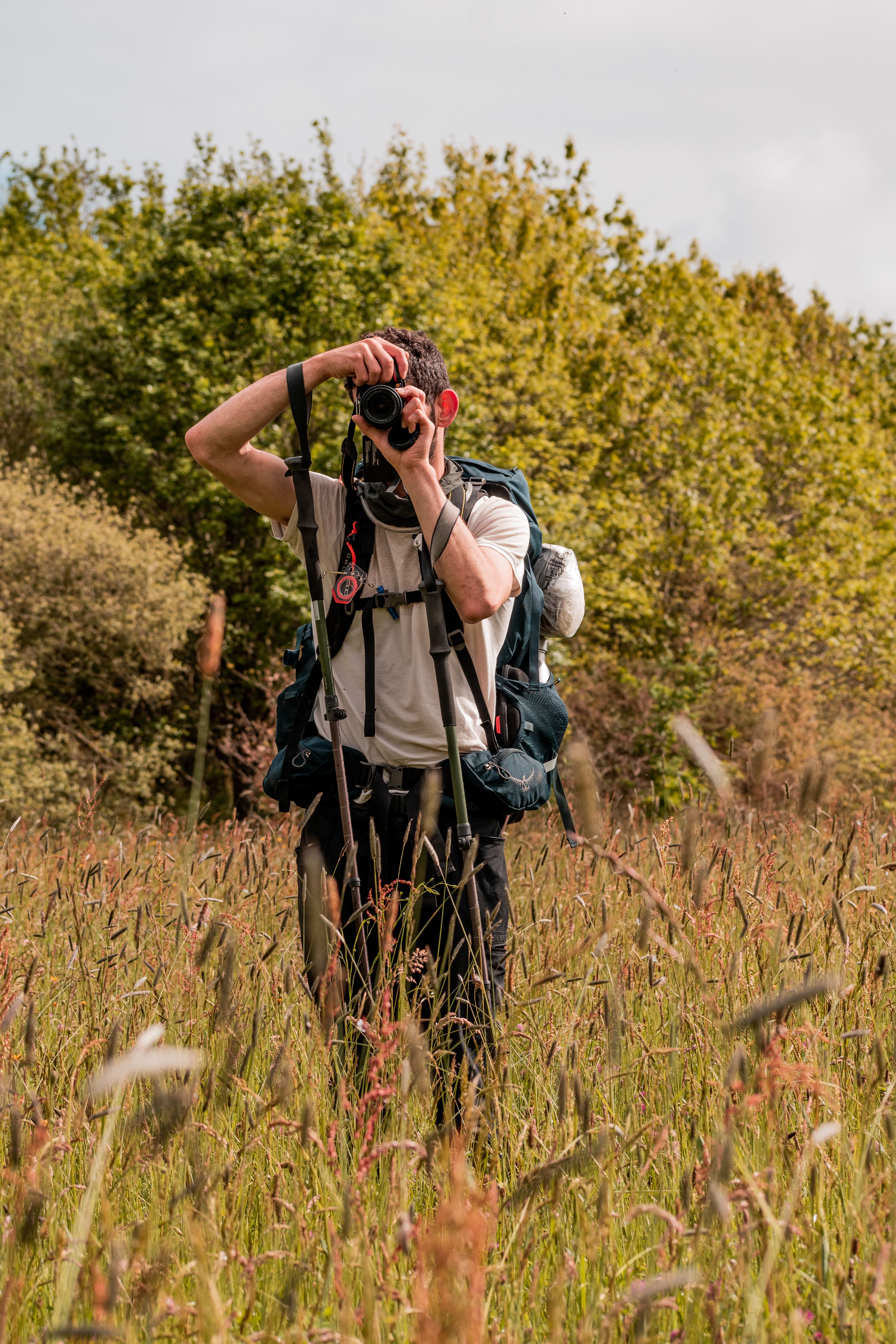 Backpacker Photographing in Rural Scenery · Free Stock Photo
