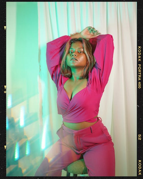 Film Photograph of a Woman in Pink Outfit Posing in Studio 