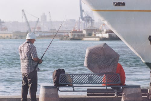 Man Fishing near the Port 
