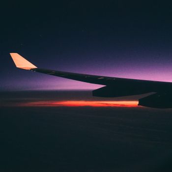 Captivating view of an airplane wing silhouetted against a colorful sunset sky.