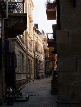 Explore a serene narrow alley in Baku, with classic architecture and elegant balconies.
