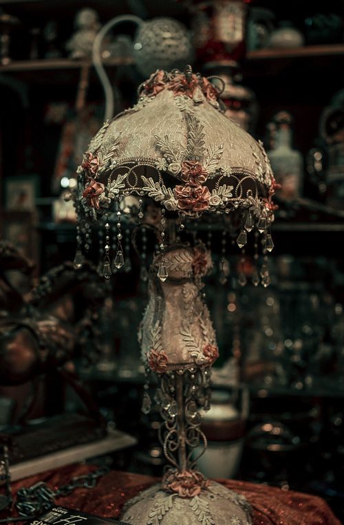 Free Elegant vintage lamp with floral embroidery and crystal accents in a retro setting. Stock Photo