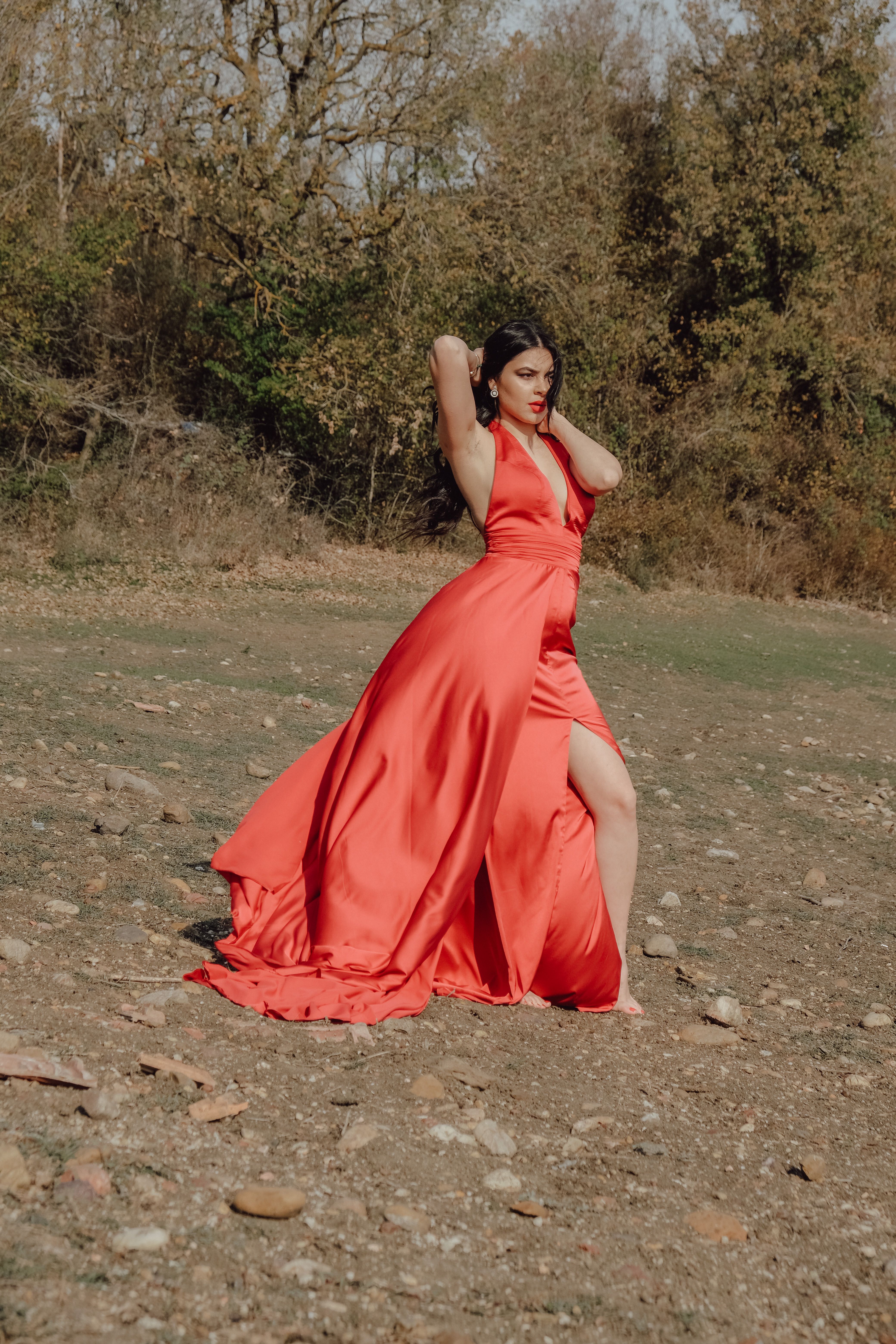 A Woman Posing in Red Dress in Park · Free Stock Photo