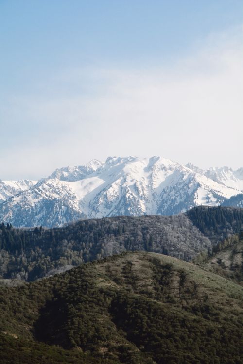 Free Snowcapped mountain range in Talgar, Kazakhstan, under a clear blue sky. Perfect for adventure and travel photography. Stock Photo