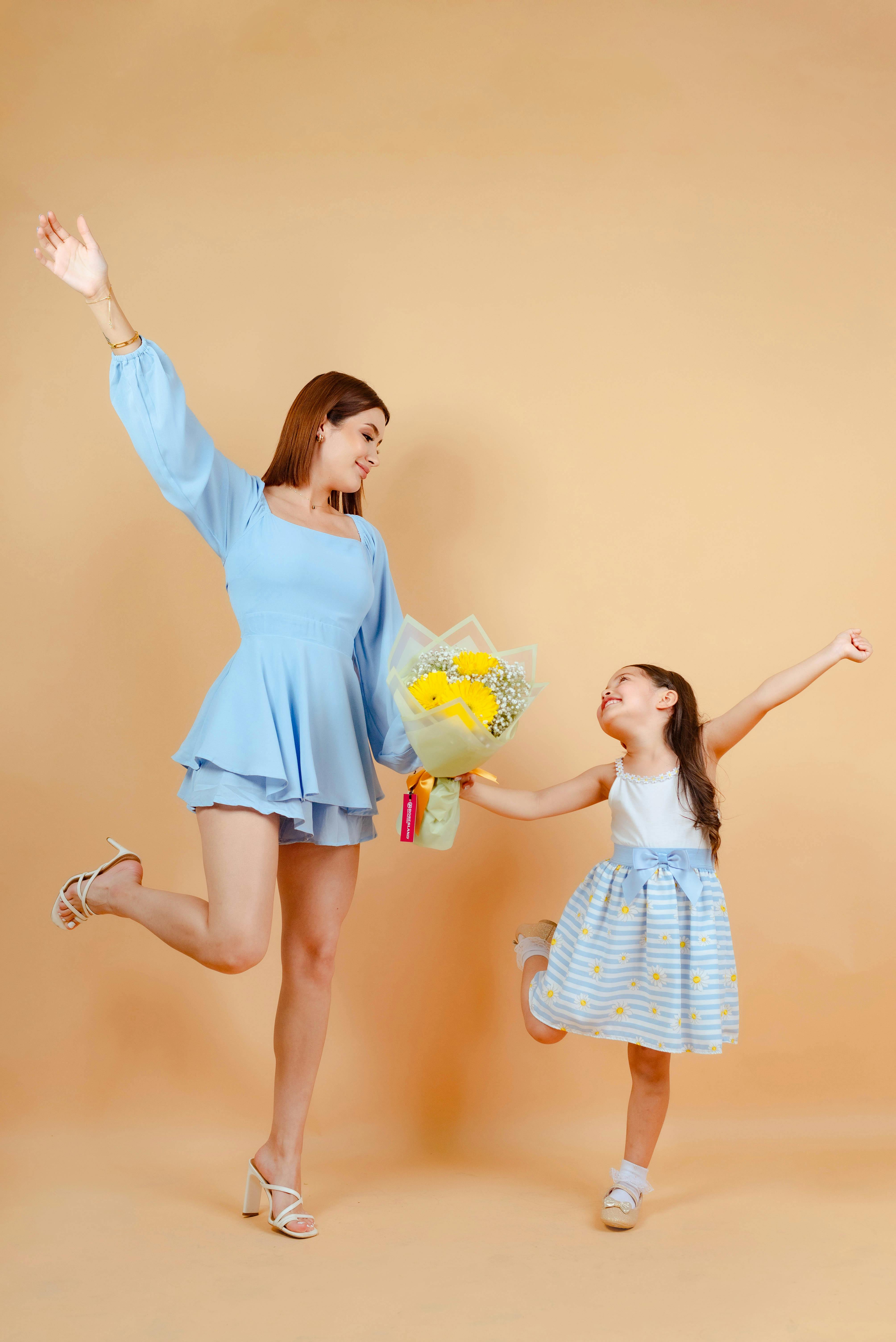 mother and daughter posing together in studio