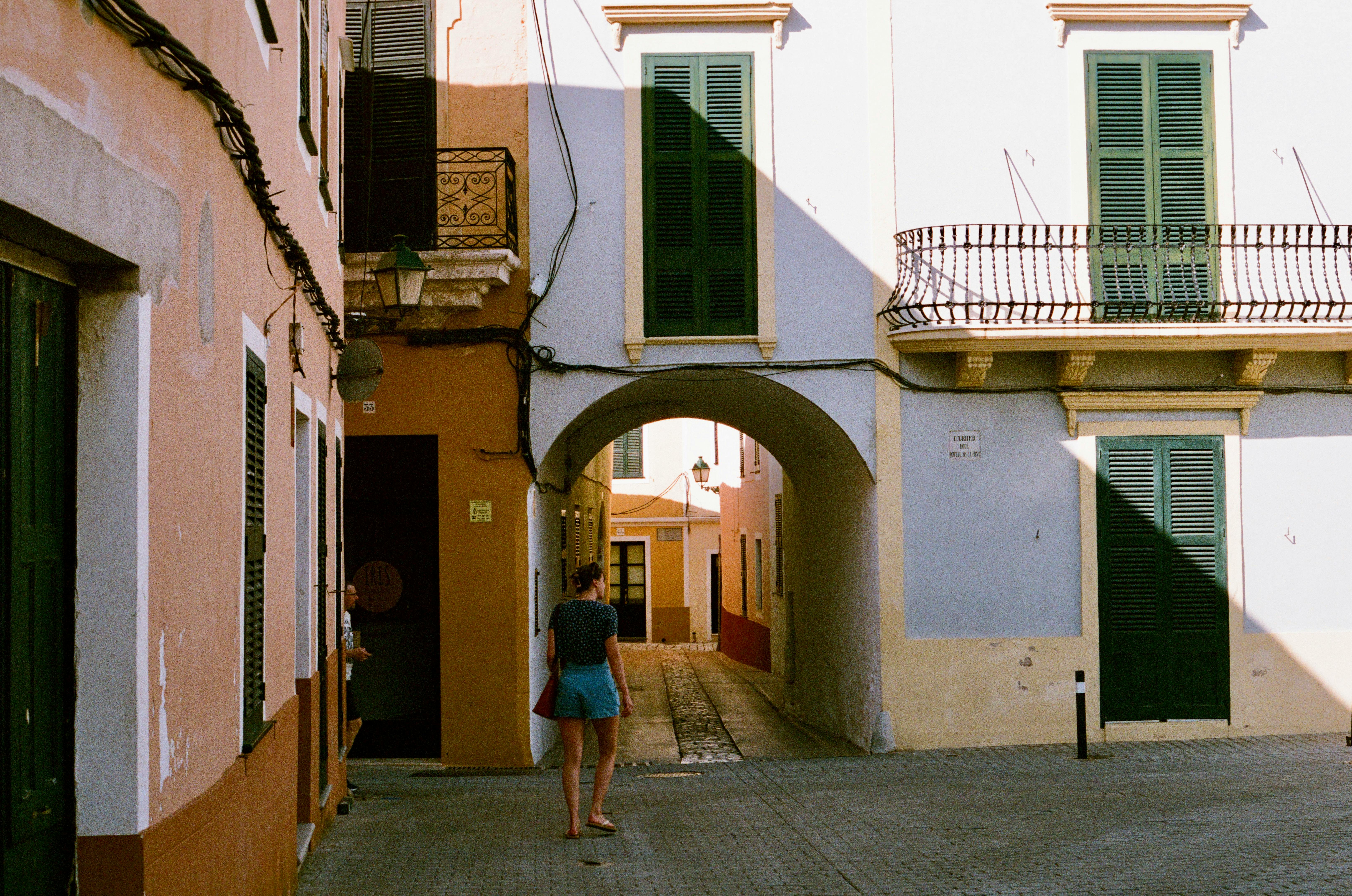 A serene summer day captures a classic European alley with traditional architecture.
