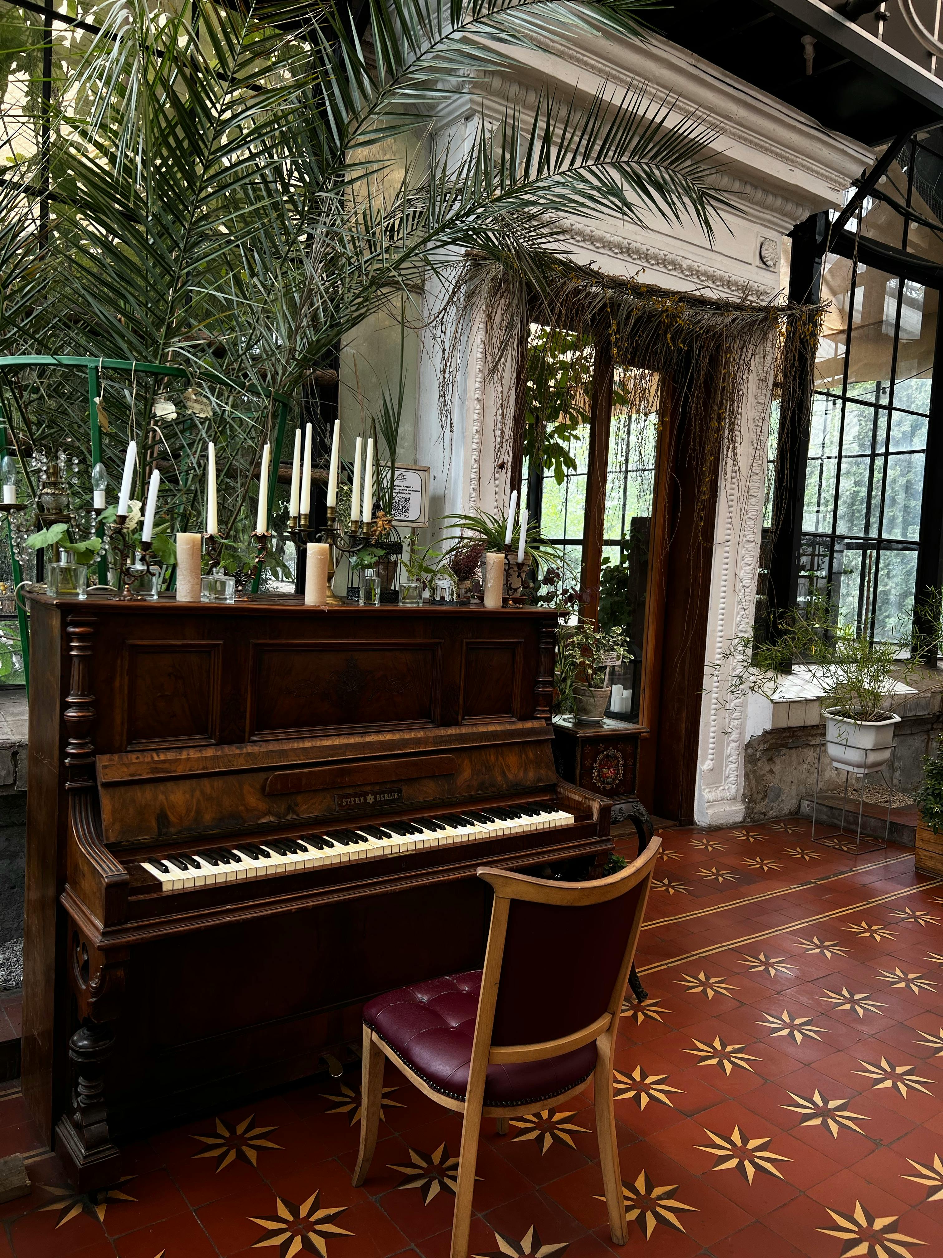 A vintage room with antique piano, plants, and elegant decor showcasing classic interior design.