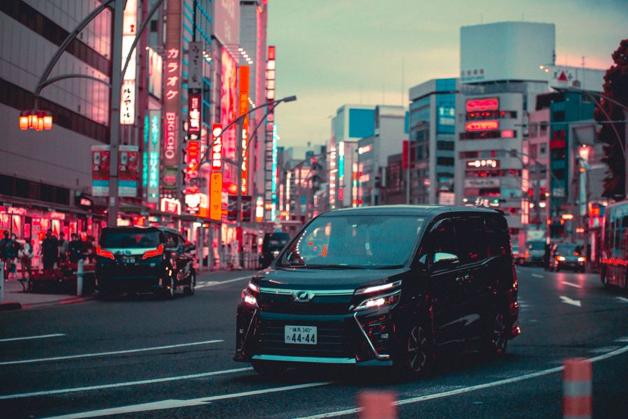 Modern Japanese minivan on the streets of Tokyo, similar to a Nissan Elgrand