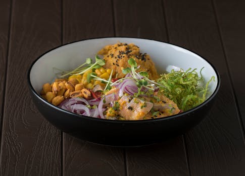 A delicious bowl of chicken, vegetables, and grains with colorful presentation.