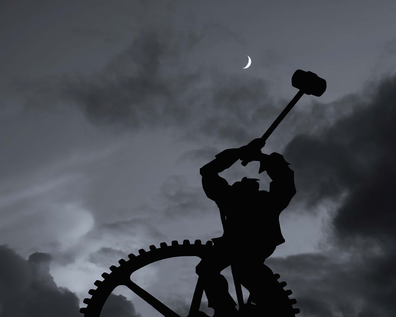 silhouette of a worker holding a hammer silhouetted against a crescent