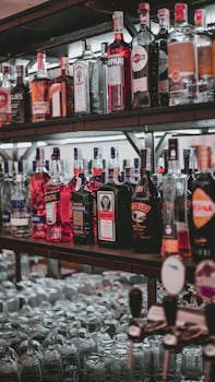A curated selection of diverse liquor bottles arranged on bar shelves for easy access.