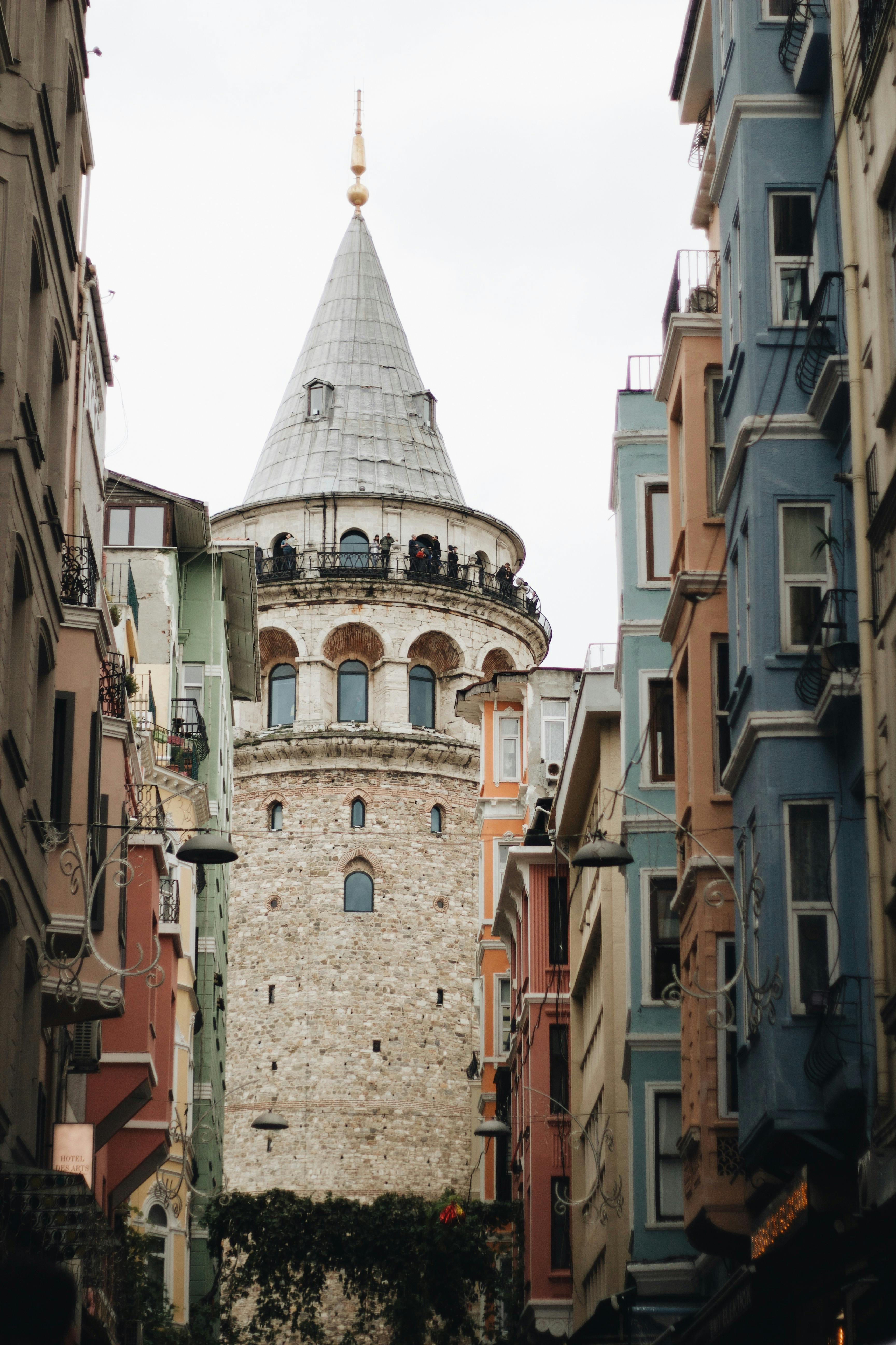 Galata Tower, an iconic landmark in Istanbul, framed by colorful urban architecture.