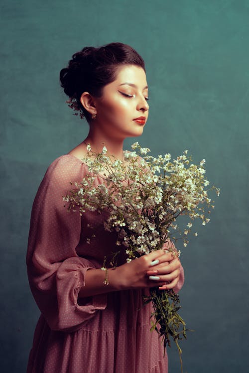 Woman Holding Flowers with Closed Eyes