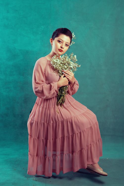 Woman in a Pink Dress Sitting with Flowers · Free Stock Photo