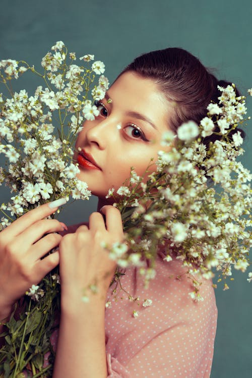 Woman Holding Flowers to her Face 