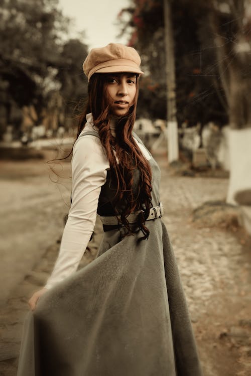 Woman in Old Fashioned Clothing Posing on Street