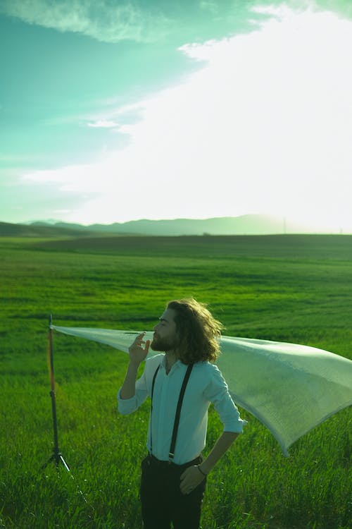 Man in a Shirt Posing on a Field in Summer